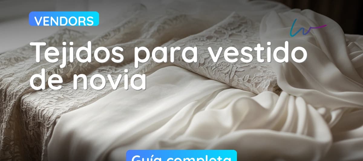 Detalle de diferentes tejidos de vestido de novia — encaje, organza y seda — sobre mesa de atelier nupcial