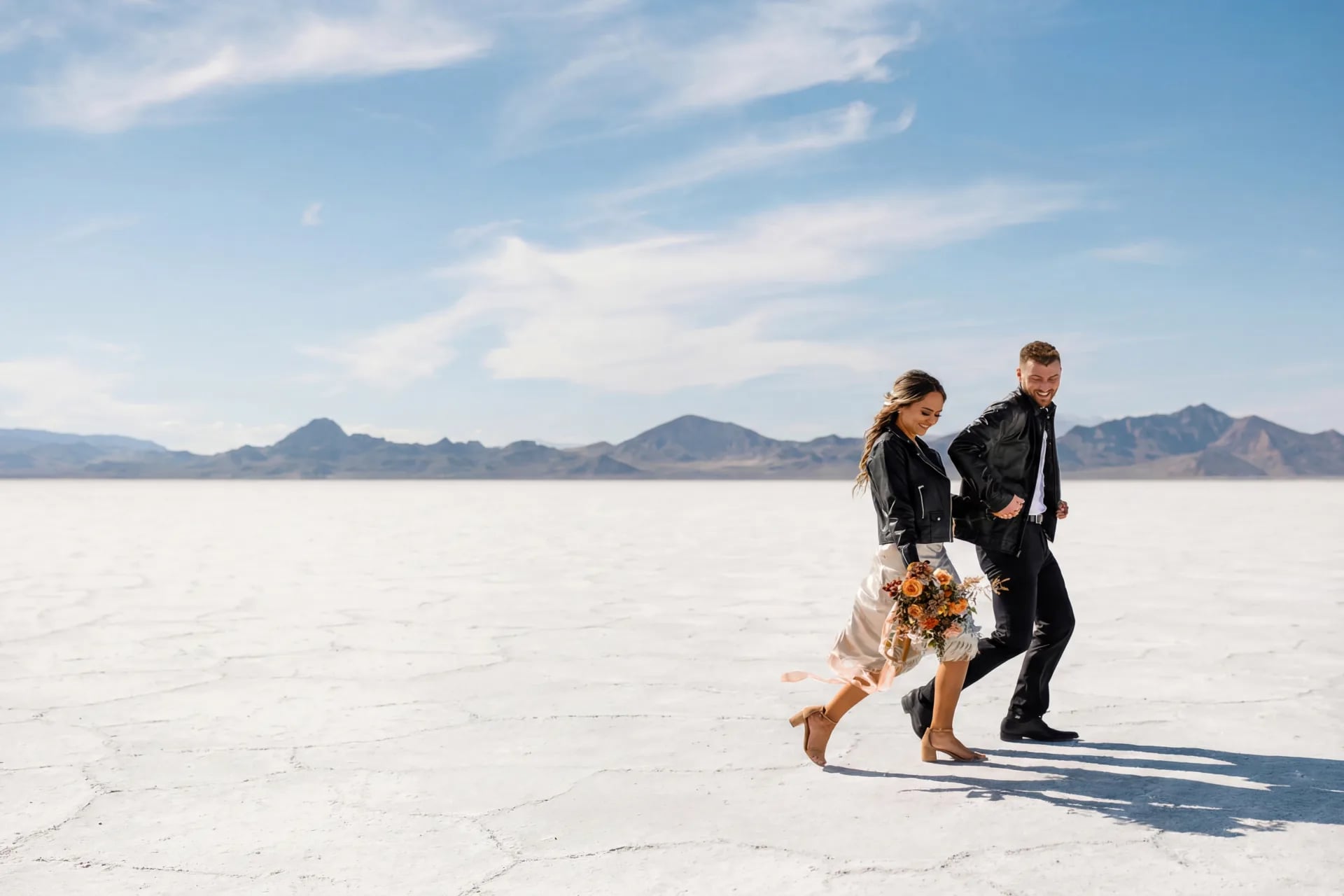 Couple walking across a vast desert landscape — your wedding, your rules